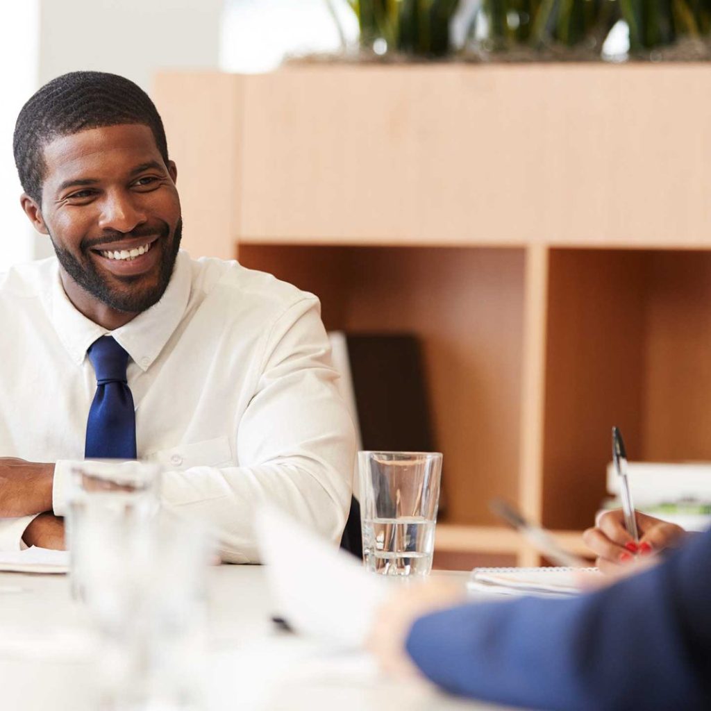 two-businessmen-sitting-around-table-meeting-in-mo-S5CLJ93.jpg